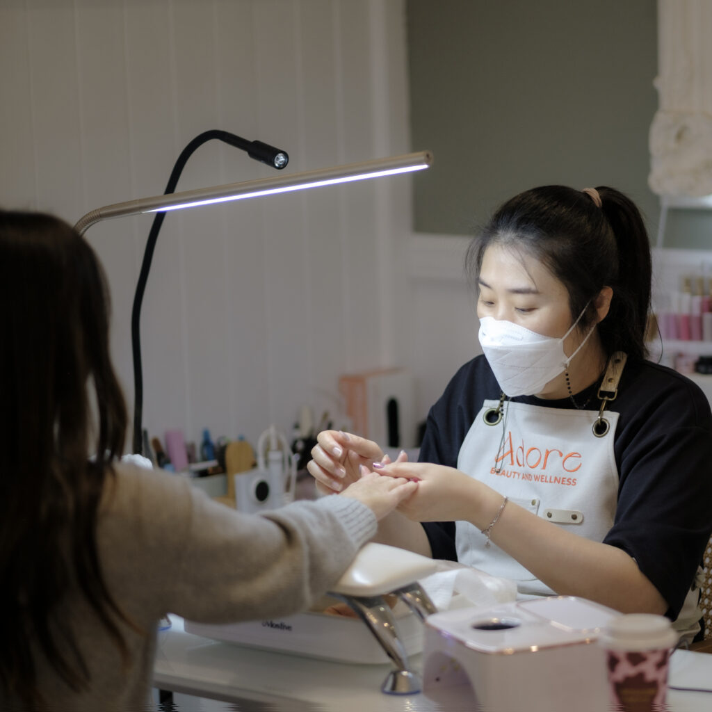 Co Founder Song Yi Du caring the customers for nail service